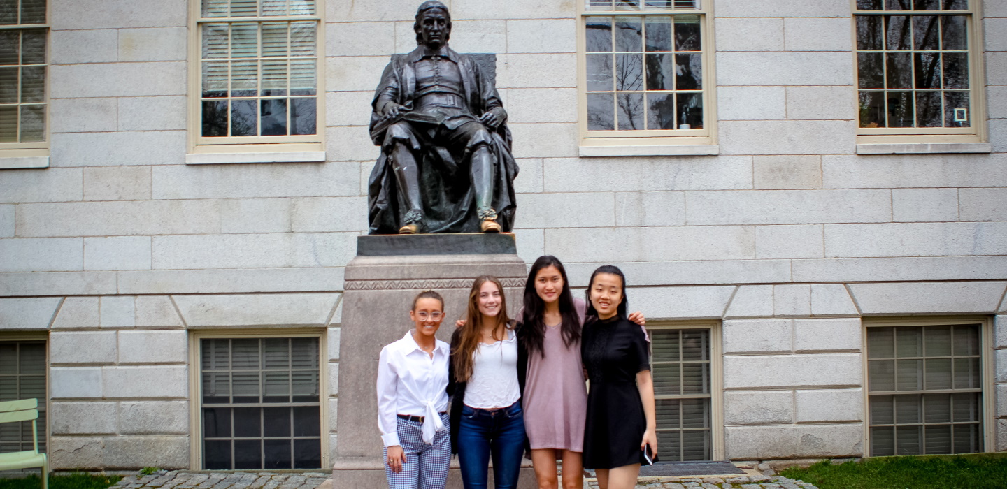 Students in front of Harvard statue